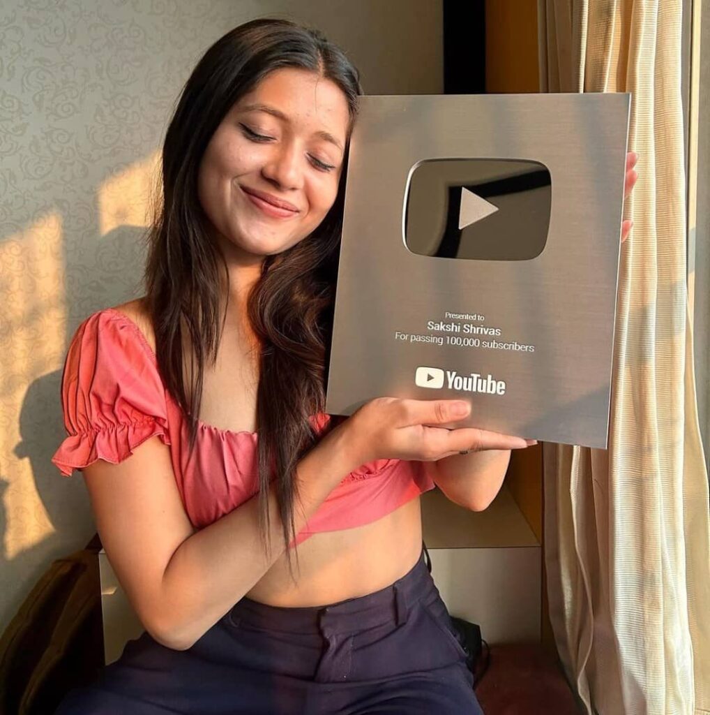 Sakshi Srinivas showing her silver YouTube playbutton